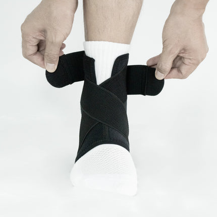 Person applying a black ankle support brace on a white background