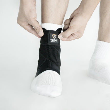 Person wearing a black ankle support brace with 'Verve Shield' branding on a white background